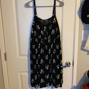 Black sun dress with skulls wearing blue glasses